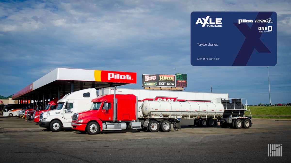 Red and white tractor trailer trucks fueling up at Pilot Company