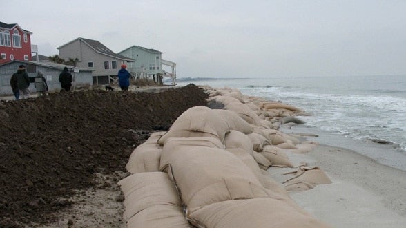 Sand bags piled up along a U.S. beach to prevent flooding.