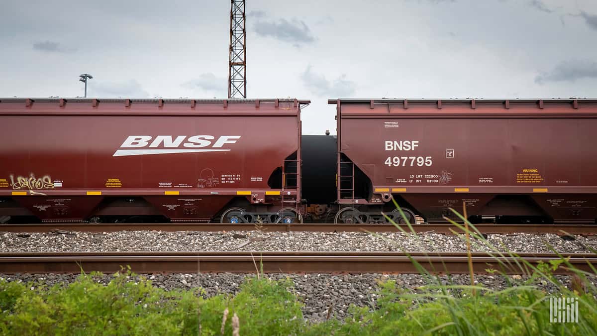 A photograph of two railcars in a rail yard.