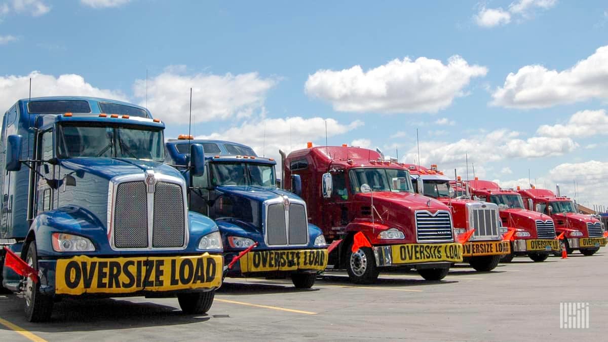 ENTREC's fleet includes semi-trucks for heavy haul transportation like the ones seen parked.