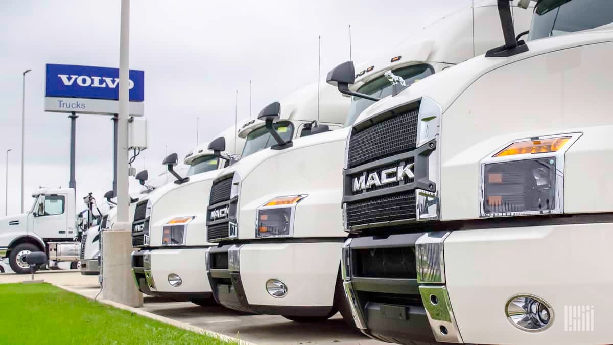 Row of Volvo trucks and signage