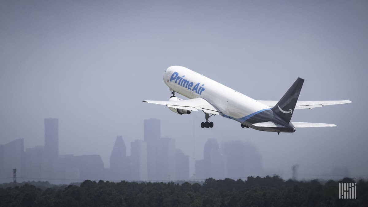 An Amazon Air plane takes off, view from behind as it gets airborne.