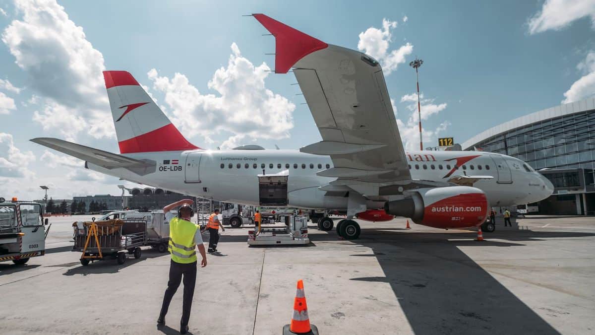 A white and red Austrian Airlines plane, viewed from the side on a sunny day. The reduced number of passenger planes in the skies has reduced space for carrying cargo.