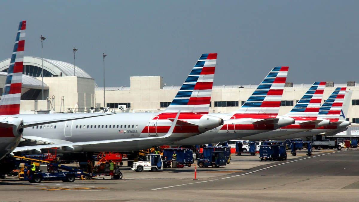 American Airlines planes with striped tails lined up at gates at Los Angeles airport. American Airlines is entering a codeshare partnership with JetBlue.