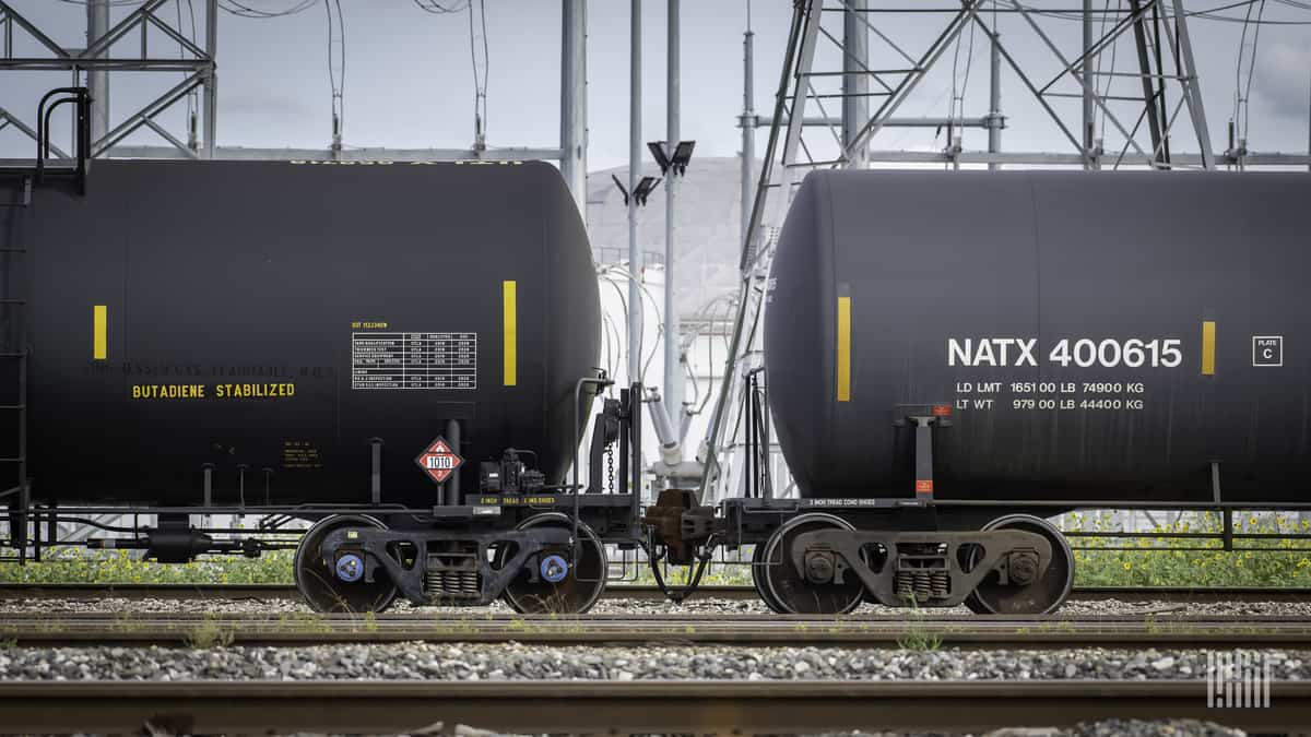 A photograph of two tank cars in a rail yard.