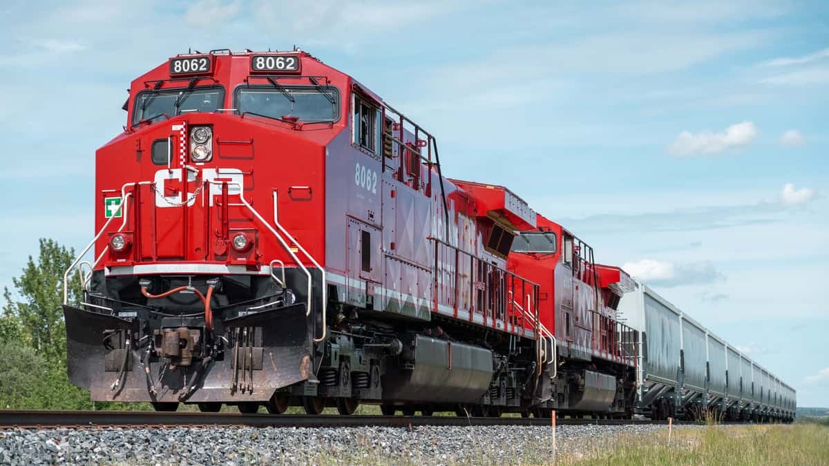 A photograph of a Canadian Pacific train traveling across a field.