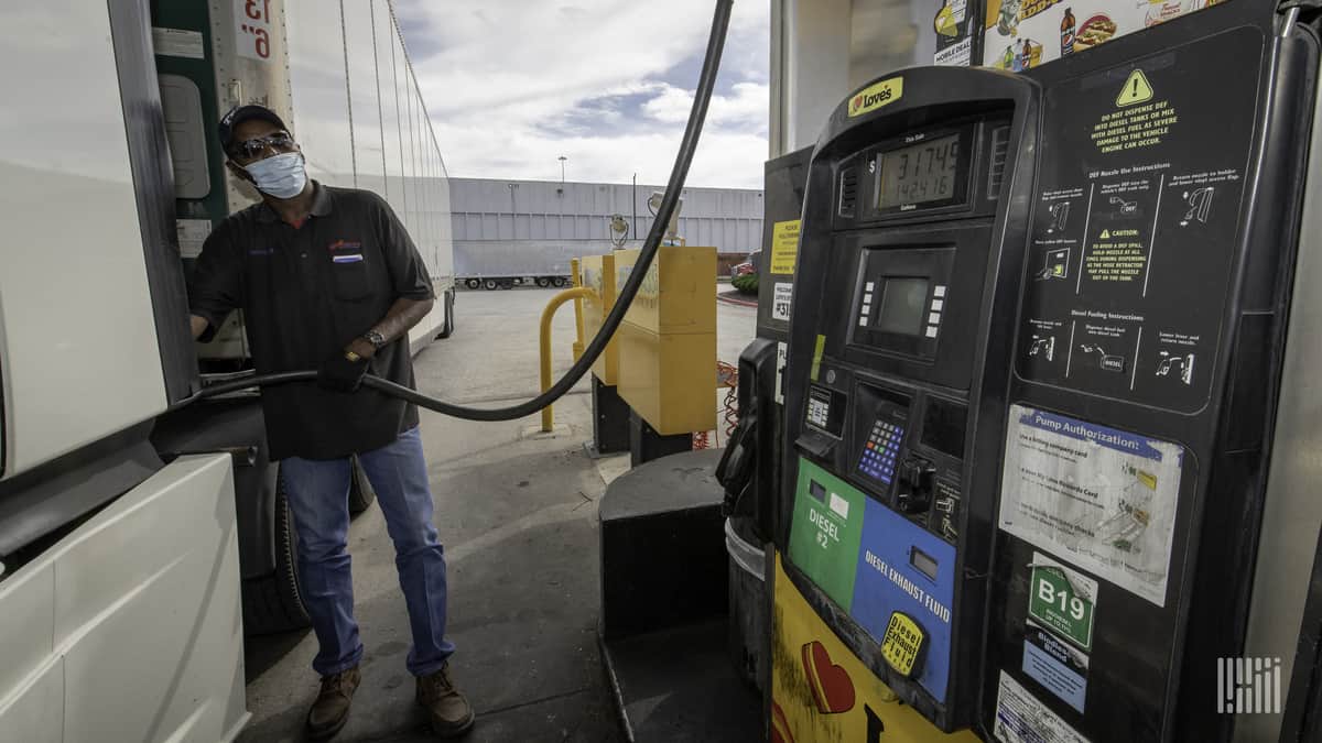 Truck driver wearing mask fuels up at a Love's Travel Stop.