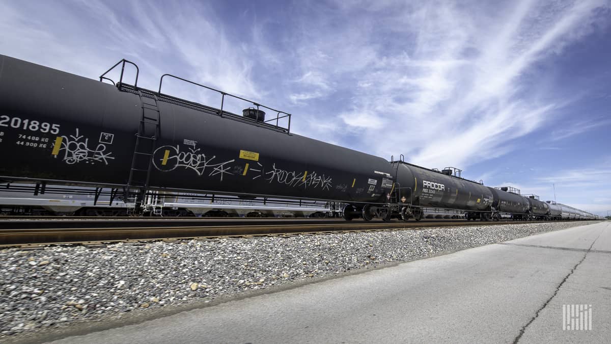 A photograph of tank cars parked at a rail yard.