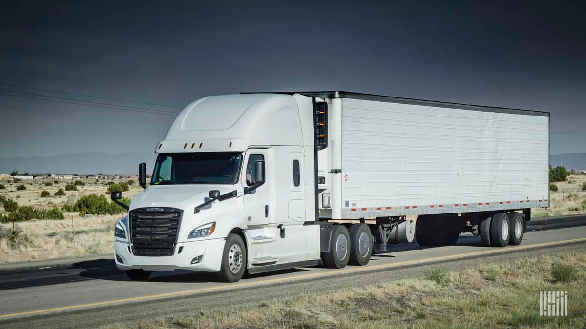 Reefer tractor-trailer heading down desert highway.