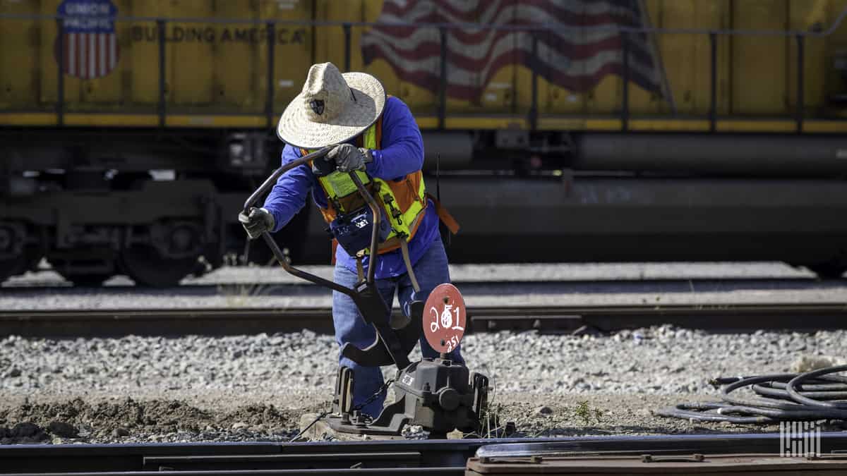 A photograph of a railroad employee and worker.