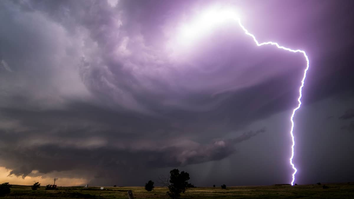 Thunderstorm with lightning bolt coming down to the ground.