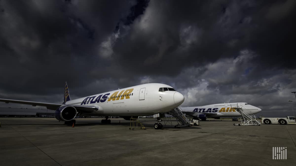 Atlas Air 747 freighters parked under a dark sky. Atlas Air announced a large Q2 profit.