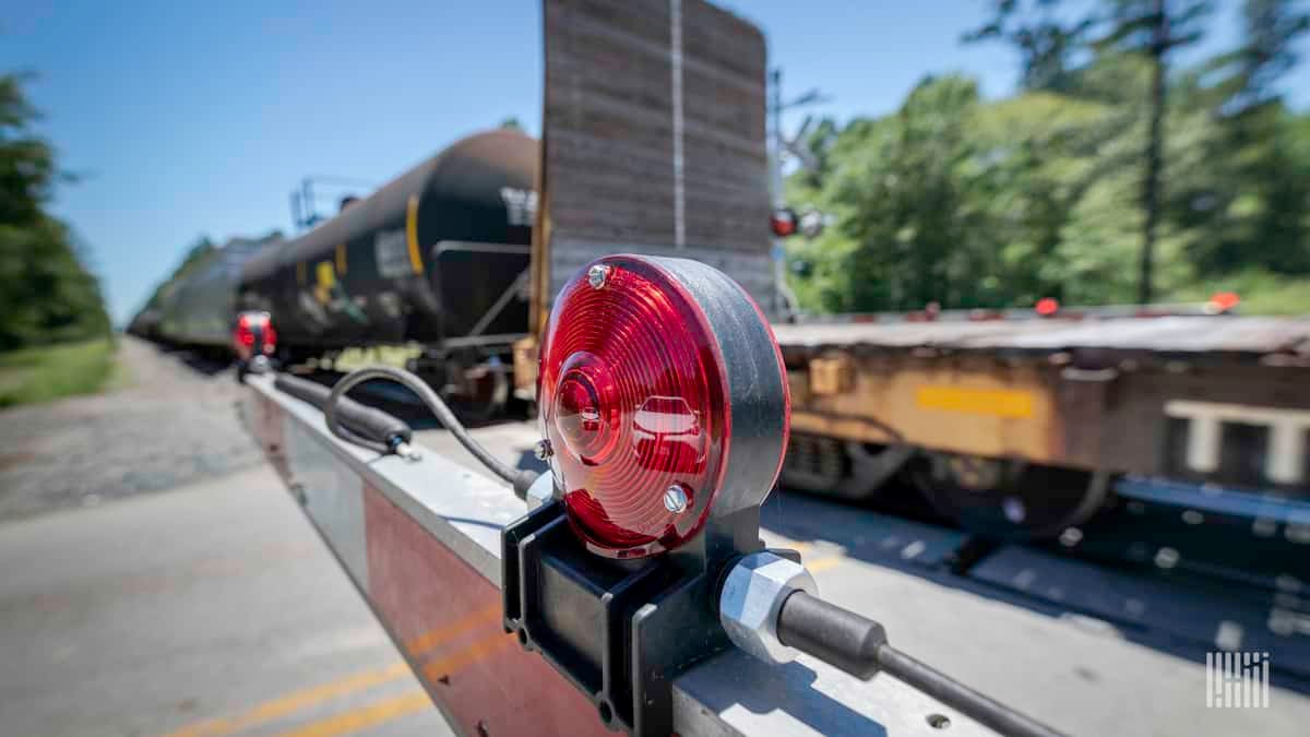 A close-up photograph of a rail crossing barrier.