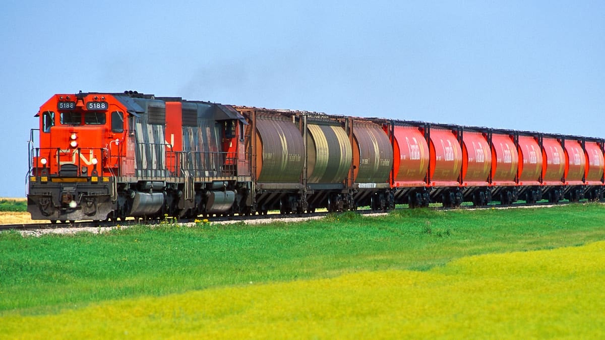 A photograph of a CN train traveling across an open field.