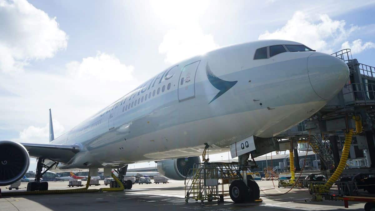 A Cathay Pacific widebody jet, up close side view. Cathay Pacific is removing seats from a couple planes to increase cargo capacity.