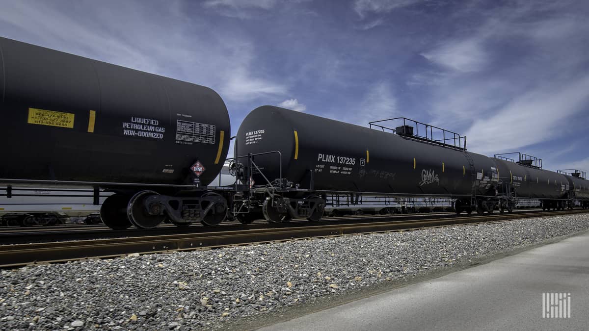 A photograph of tank cars parked at a rail yard.