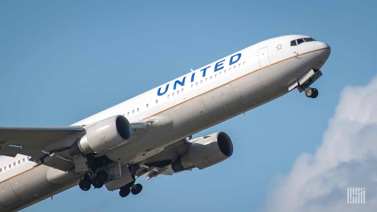 A white United Airlines planes takes off into bright blue sky. United is adding more flights between San Francisco and Shanghai.