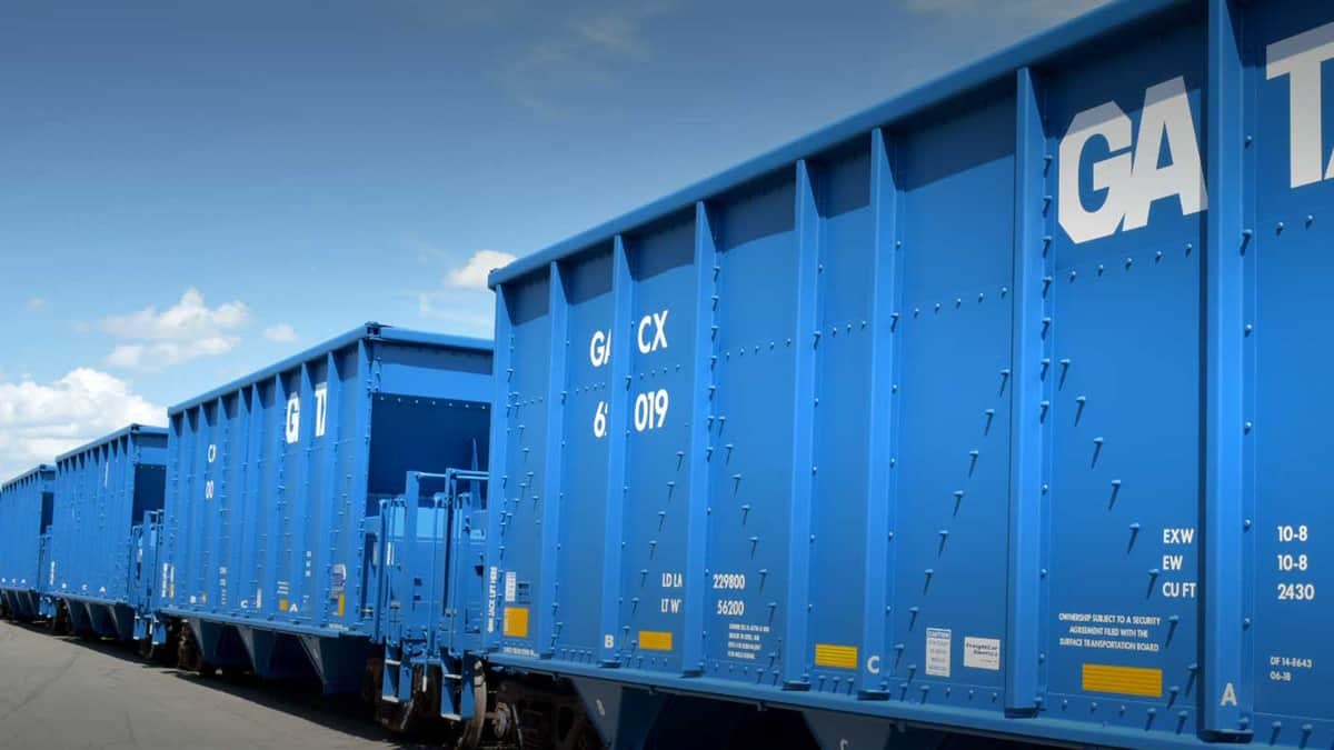 A photograph of two railcars at a rail yard.