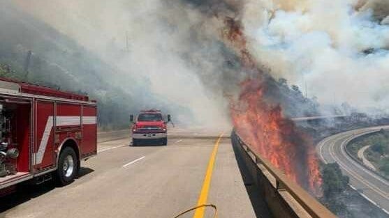 Fire trucks on highway near the Grizzly Creek wildfire in Colorado.