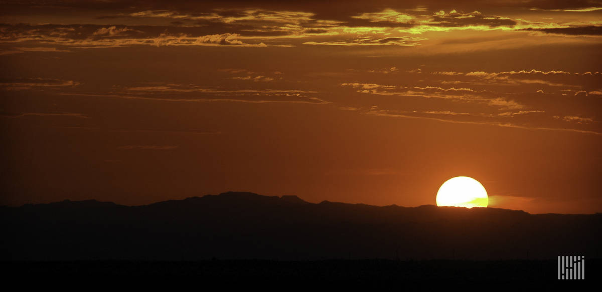 Bright sun along the horizon at dusk/dawn.