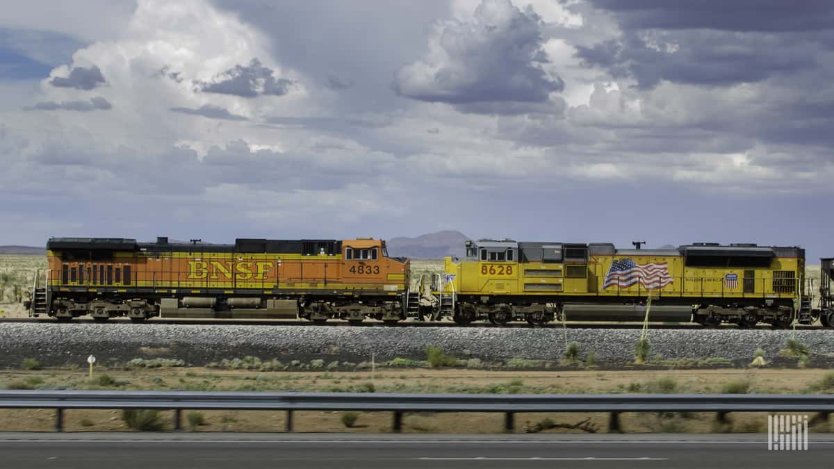 A photograph of two locomotives parked in a field.