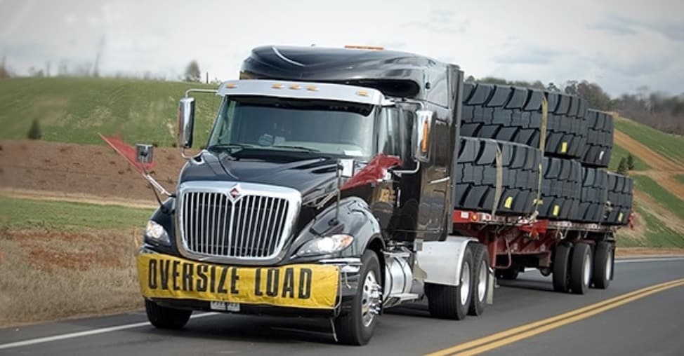 Daseke affiliate truck carrying tires on highway