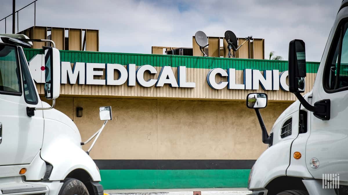 Trucks parked in front of a medical clinic. Canadian truckers are reporting that they can't get medical care unless they self-isolate for 14 days.