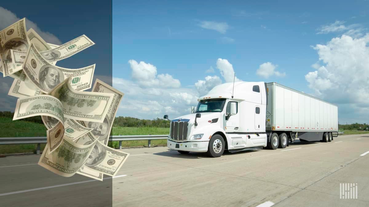 White truck driving down highway with a stack of cash flying to the left