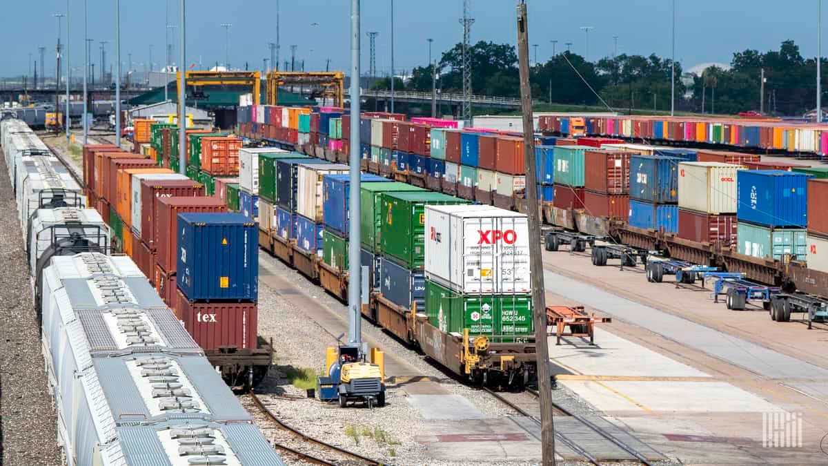 A photograph of intermodal containers parked at a rail yard.