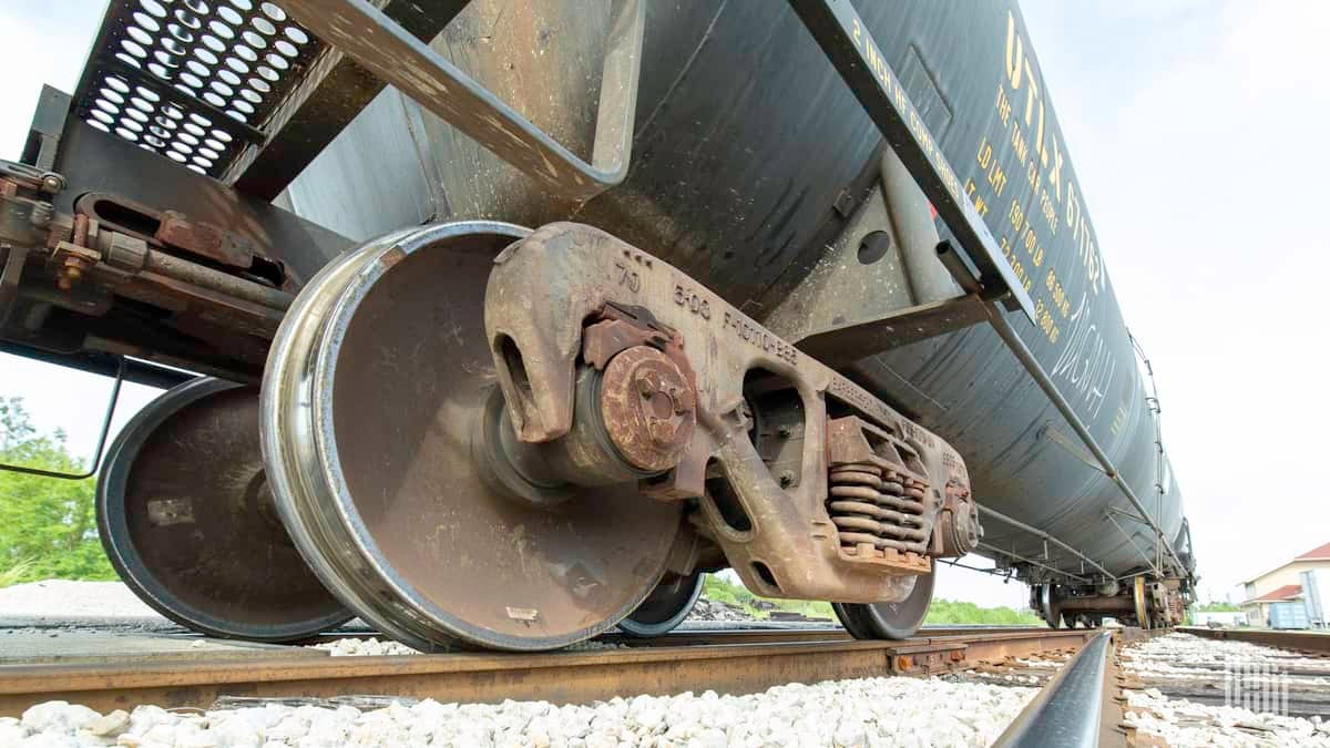 A photograph of a railcar wheel on a track.