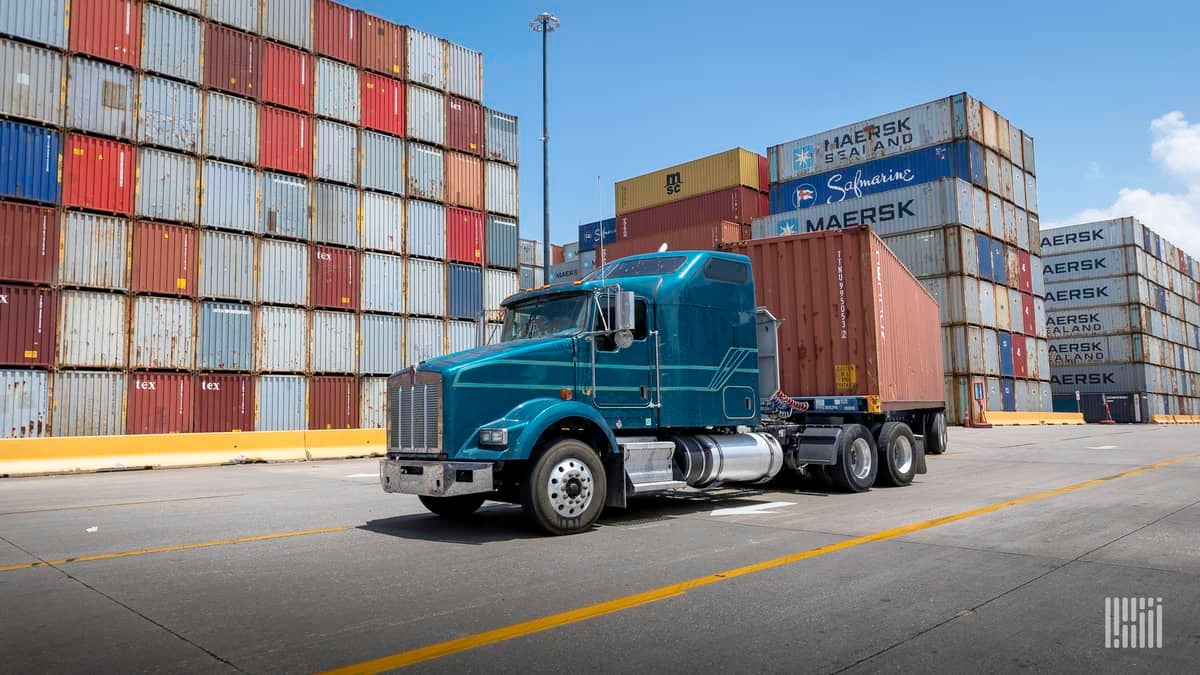 Drayage truck at port surrounded by containers