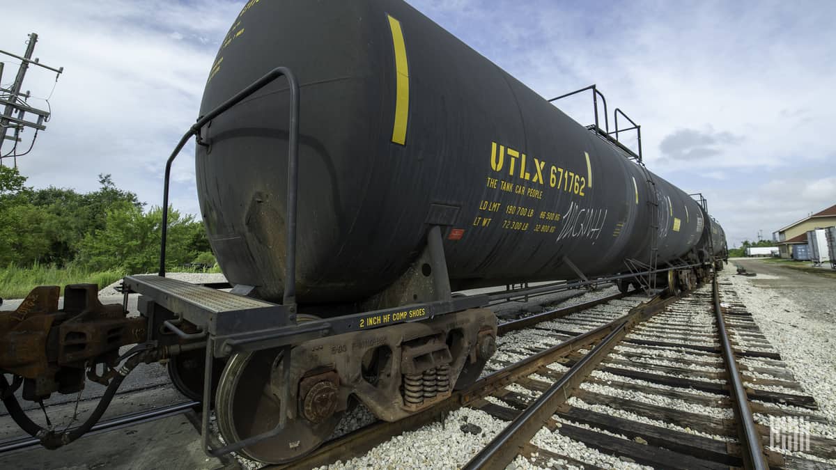 A photograph of a tank car in a rail yard.