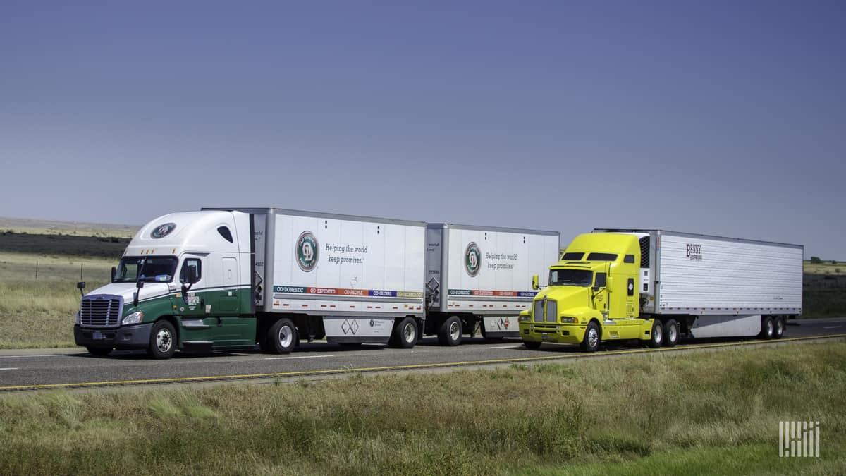 Old Dominion double next to truckload rig on highway