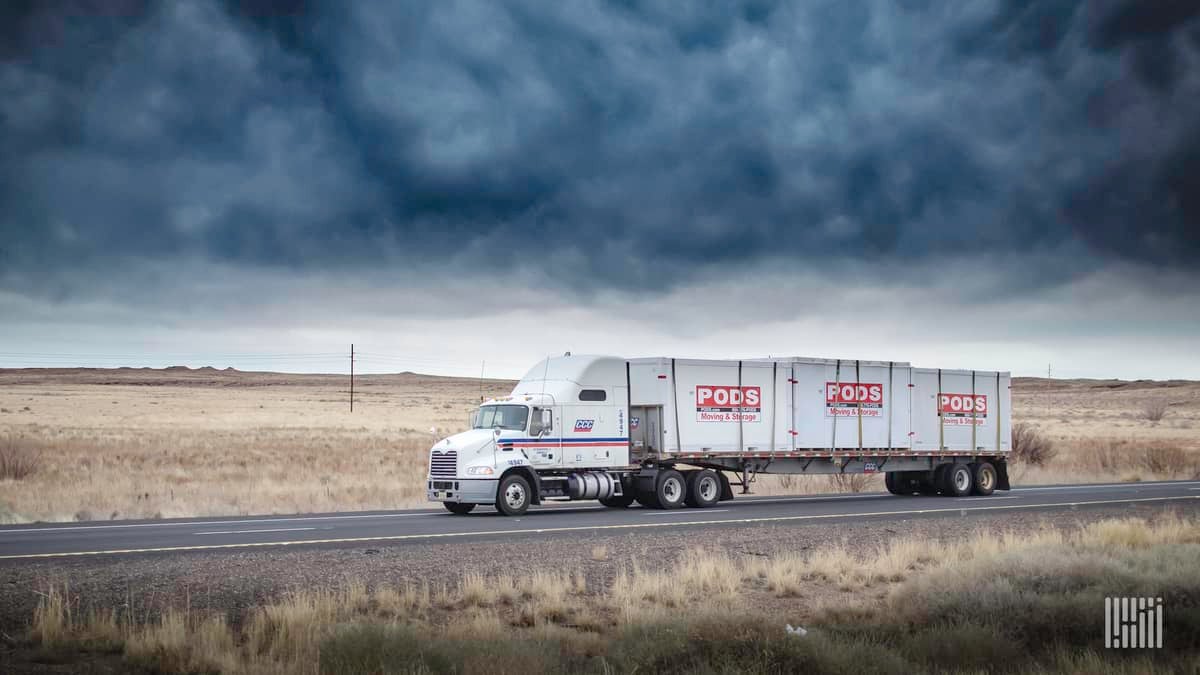 A tractor-trailer of CCC Transportation drives on a road. TFI International has acquired CCC from Comcar Industries.