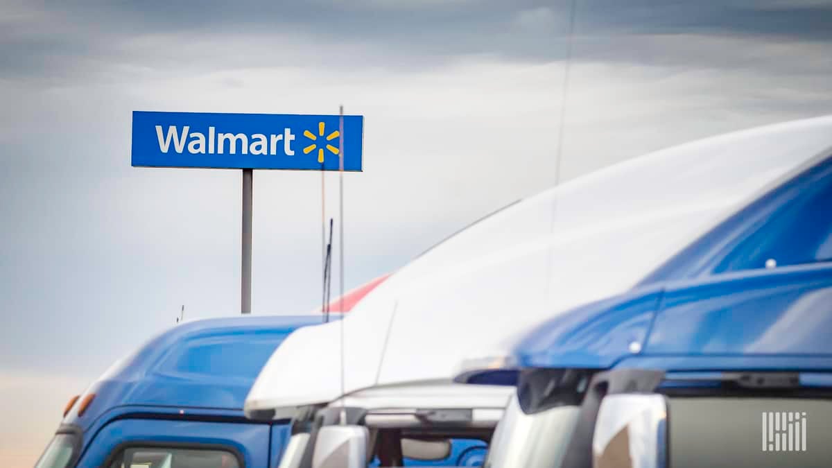 Trucks in front of a Walmart facility. Walmart Canada says a blockchain payment platform had dramatically reduced invoice disputes.