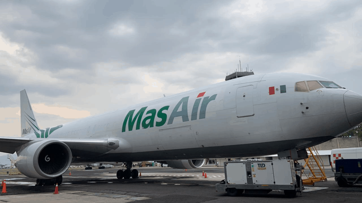 A white cargo jet parked, waiting for a load.