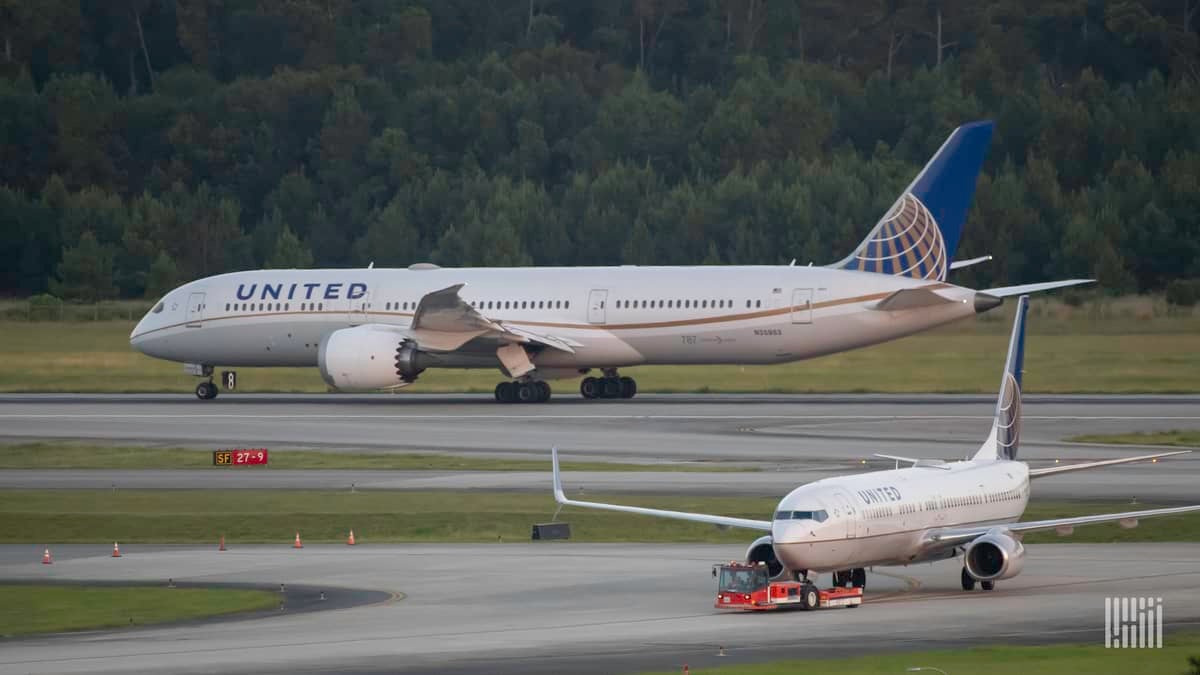 White jets with blue tails from United Airlines on the taxiways at Houston Airport.