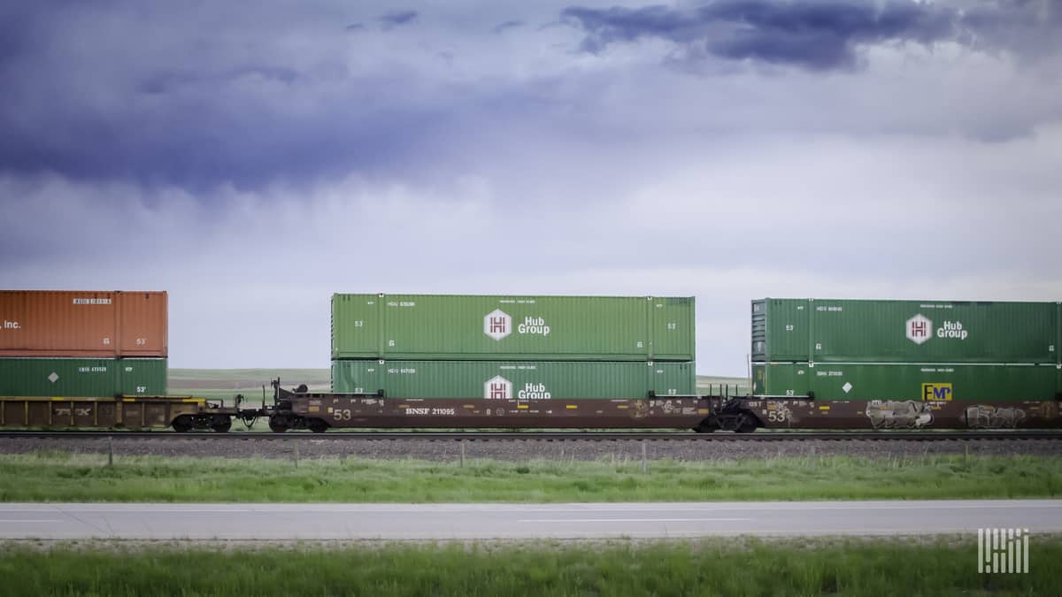 Hub containers double stacked on well cars