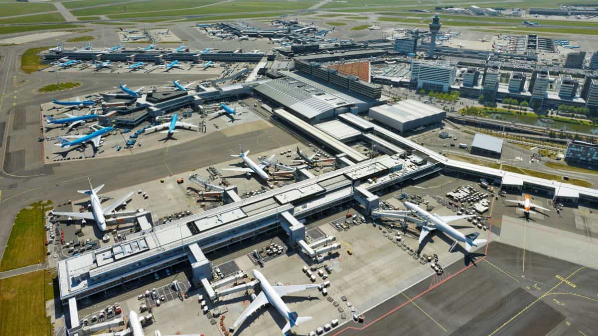 Aerial view of Amsterdam Airport terminals with planes.