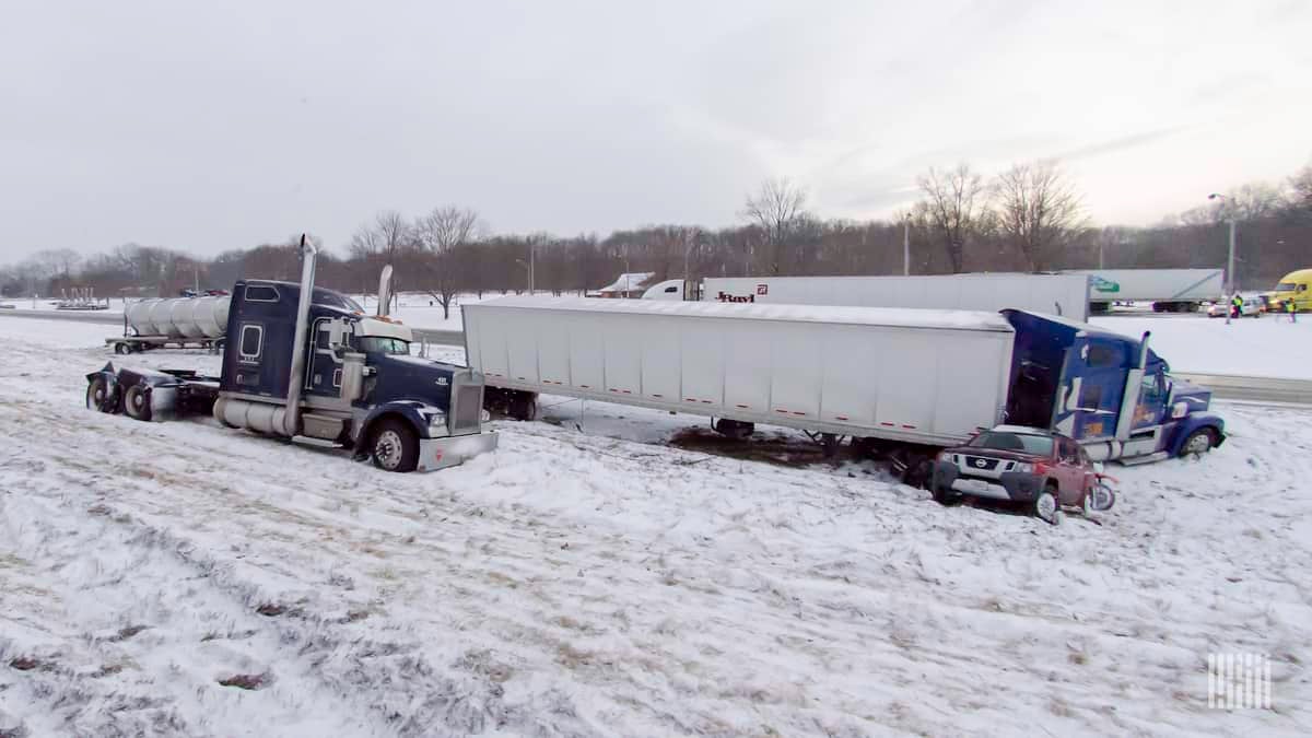 Tractor-trailer accident on a snowy highway.