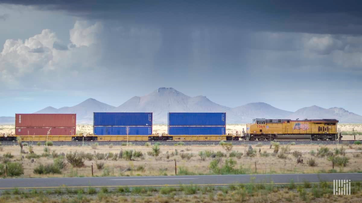 A photograph of a Union Pacific train crossing a desert field.