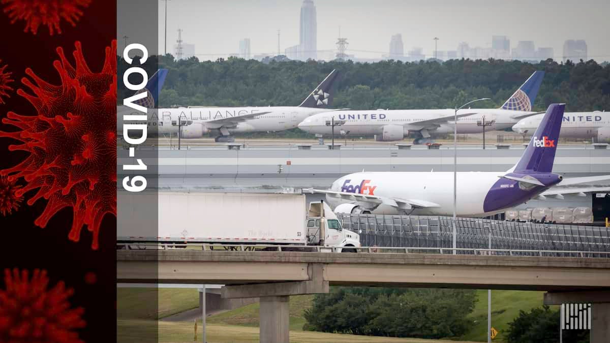 Airplanes parked, moving at airport. Truck driving on ramp. Lots of activity at airport.