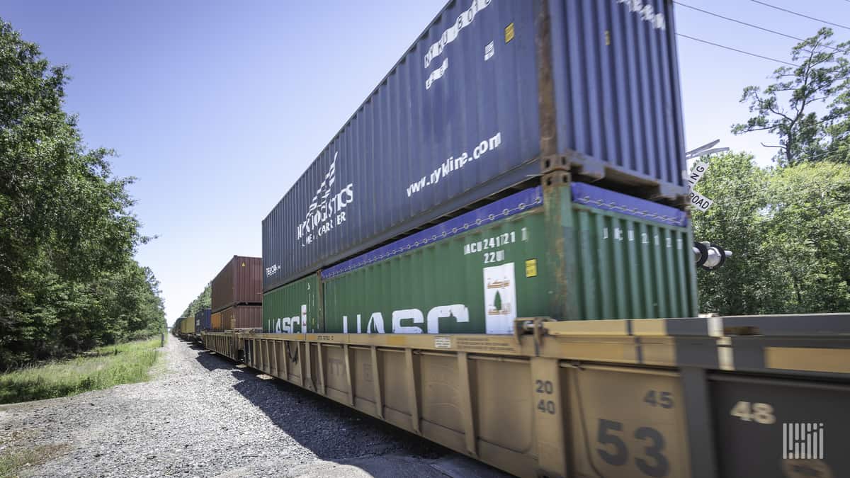 A photograph of a train hauling containers.