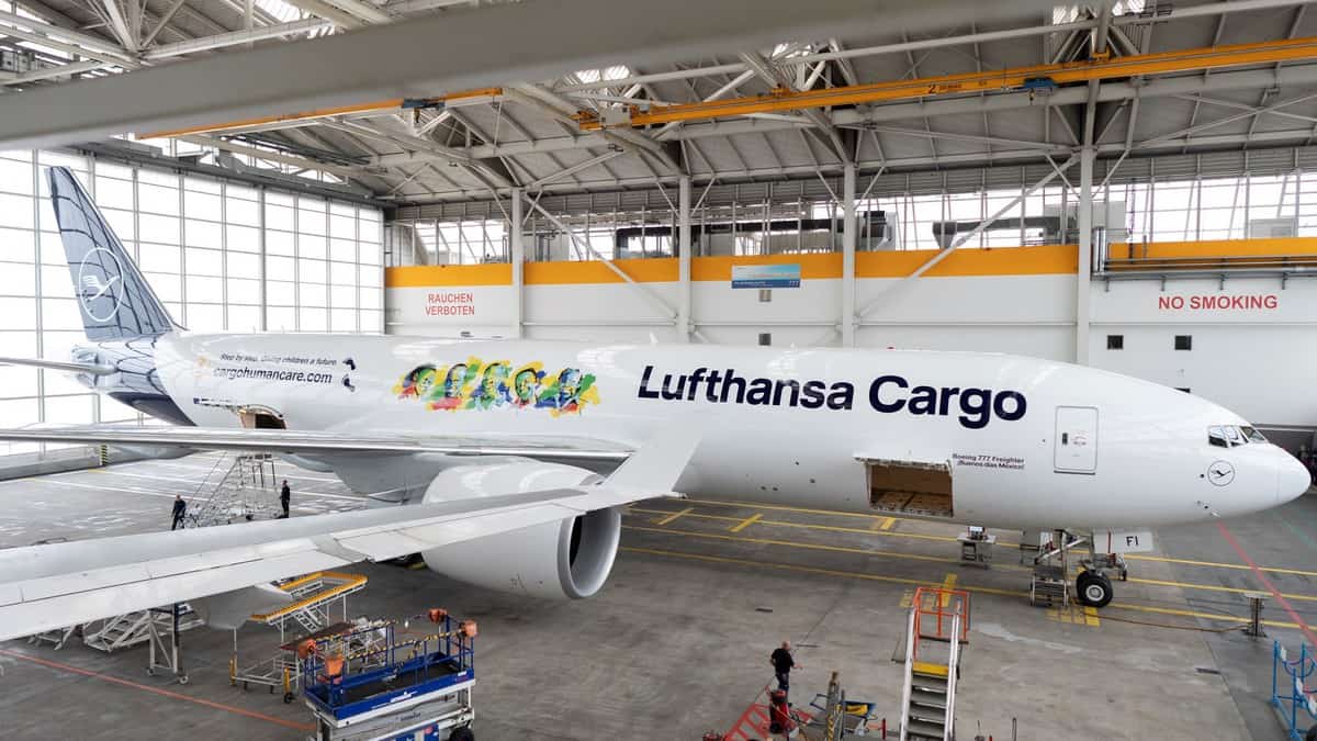 A large white jet inside a hangar.hangar.