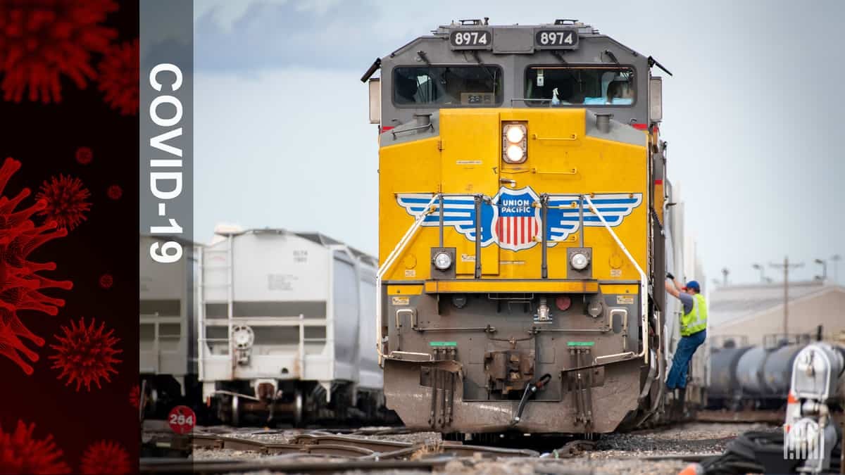 A photograph of a man climbing aboard a Union Pacific locomotive. To the left is a graphic that says "COVID-19."