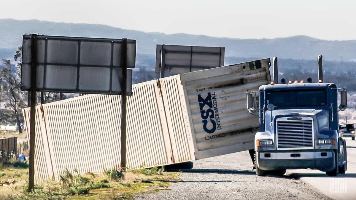 Tractor-trailer rolled over on side of Interstate 15 in California.