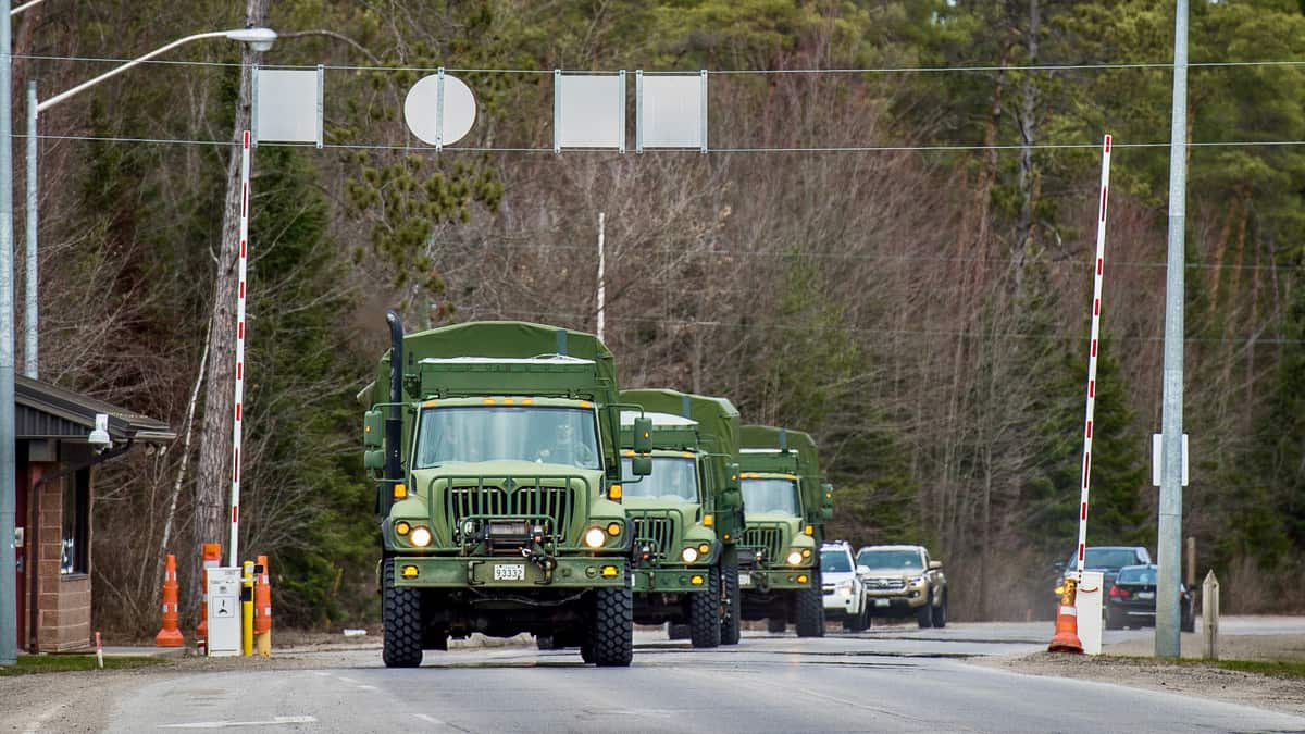 A convoy of military vehicles enters Canadian Forces Base Borden. The Canadian Armed Forces will be helping distribute COVID-19 vaccines.