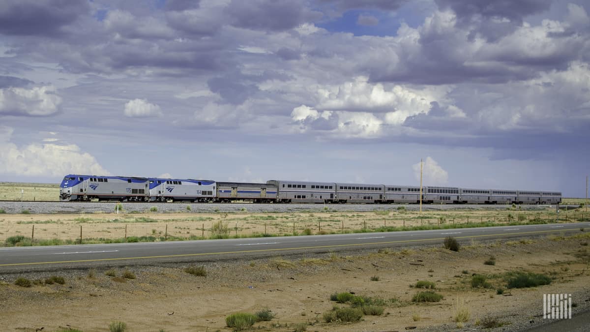 A photograph of an Amtrak train traveling across a grassy field.