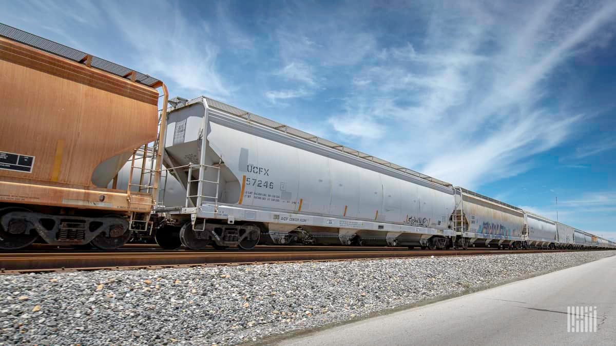 A photograph of hopper cars in a rail yard.