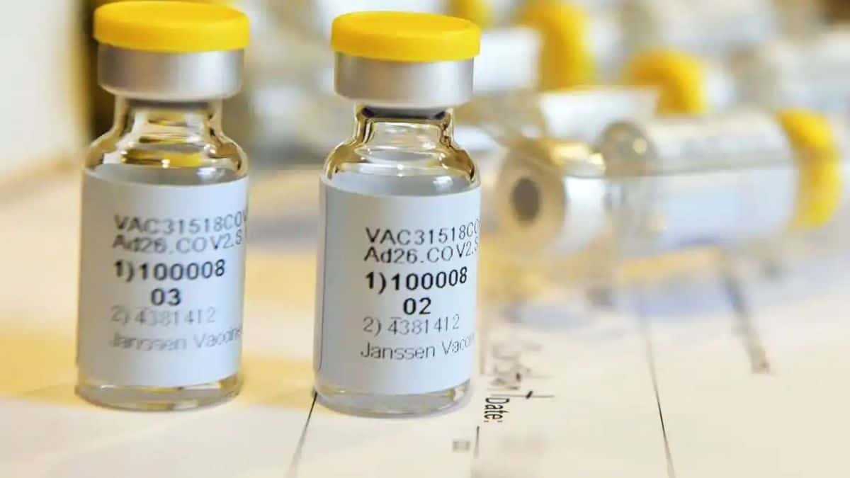 Close up of vials of vaccine with yellow caps.